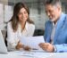 business owner and solicitor reviewing documents at computer