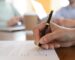 man signing contract with two other people watching