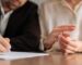 couple signing divorce papers