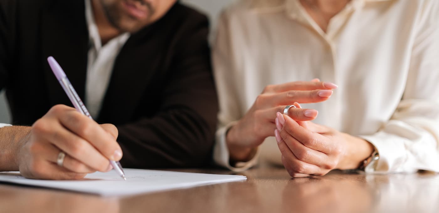 couple signing divorce papers