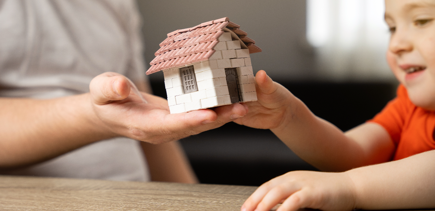 A father gives his son a small house.