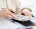 woman working out property tax with calculator
