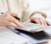 woman working out property tax with calculator
