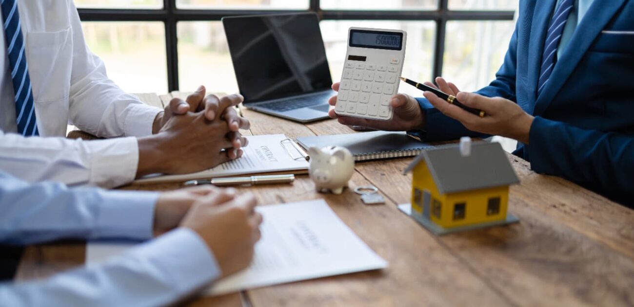 two people discussing housing tax and fees with an agent