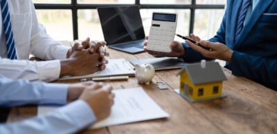 two people discussing housing tax and fees with an agent