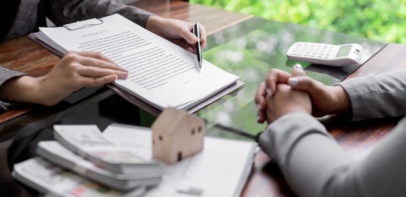 two people discussing and signing a estate contract